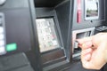 Hand swiping credit card at gas pump station. Royalty Free Stock Photo