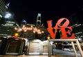 Philadelphia, Pennsylvania, U.S.A - December 3, 2022 - The famous Love sign and the buildings in the city by Christmas Village