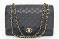 Photo of black Chanel handbag brand Editorial on white background.