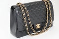 Photo of black Chanel handbag brand Editorial on white background.