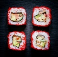 Philadelphia Roll with caviar, top view, a dark stone background