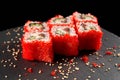 Philadelphia roll covered with tobiko roe. Royalty Free Stock Photo