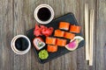 Philadelphia roll sushi with salmon, prawn, avocado, cream cheese served on wooden background. Sushi menu. Royalty Free Stock Photo