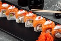 Philadelphia roll sushi with salmon, smoked eel, cucumber, avocado, cream cheese, red caviar. Sushi menu. Japanese food Royalty Free Stock Photo