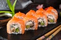 Philadelphia roll sushi with salmon, smoked eel, cucumber, avocado, cream cheese, red caviar. Royalty Free Stock Photo