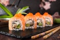 Philadelphia roll sushi with salmon, smoked eel, cucumber, avocado, cream cheese, red caviar. Sushi menu Royalty Free Stock Photo