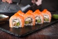 Philadelphia roll sushi with salmon, smoked eel, cucumber, avocado, cream cheese, red caviar. Sushi menu Royalty Free Stock Photo