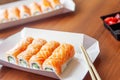 Philadelphia rolls classic on the wooden table. Salmon, cheese, cucumber, avocado, wooden sticks. Japanese sushi home delivery. Royalty Free Stock Photo