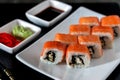 Traditional Japanese cuisine. Philadelphia sushi roll made of fresh salmon, avocado and cream cheese with black rice Royalty Free Stock Photo