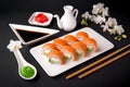 Philadelphia Sushi Roll made of Fresh Salmon, Avocado and Cream Cheese inside. Royalty Free Stock Photo