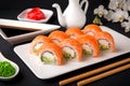 Philadelphia Sushi Roll made of Fresh Salmon, Avocado and Cream Cheese inside. Royalty Free Stock Photo