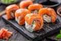 Philadelphia Sushi Rolls Set, Uramaki, Nori Maki or Futomaki Sushi with Raw Fish Fillet on Wood Royalty Free Stock Photo