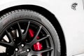 Closeup of Srt rim with red Brembo caliber and hellcat logo