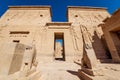 Philae Temple entrance guarded by two lion statues in Egypt