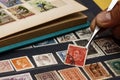 Philatelist looks at postage stamps Royalty Free Stock Photo