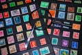 Philately magnifying glass and tweezers to see stamp collection