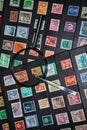 Philately magnifying glass and tweezers to see stamps collection Royalty Free Stock Photo