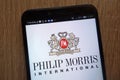 Philip Morris International logo displayed on a modern smartphone