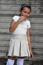 Philippina Child And Shyness Wearing Skirt In Front Of Wall