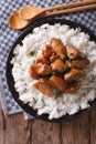 Philippine cuisine: Adobo with rice close-up. Vertical top view