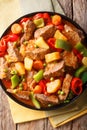Philippine cuisine: kaldereta beef with vegetables close-up. Vertical top view