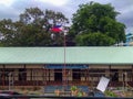 Philippine flag attached in a flag pole in front of a school