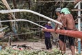 Philippine tribal fisherman repairing the float of a traditional fisherman boat on a beach in Port Barton in the Philippines