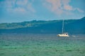 Philippines, Boracay island, Puka Beach. A white yacht is moored in the sea with a white rubber boat attached. Against Royalty Free Stock Photo