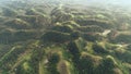 Philippines countryside hills aerial view: greenery landscape, small hillside lake, houses at Mayon