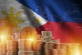 Philippines flag and big amount of golden bitcoin coins and trading platform chart. Crypto currency