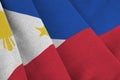 Philippines flag with big folds waving close up under the studio light indoors. The official symbols and colors in