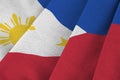 Philippines flag with big folds waving close up under the studio light indoors. The official symbols and colors in