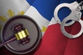 Philippines flag with judge mallet and handcuffs in dark room. Concept of criminal and punishment, background for judgement topics