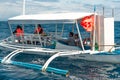 Philippines, Negros Island - Feb 05, 2018: Tourists watch wild dolphins in the sea at Manjuyod White Sand bar