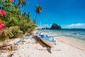 The Philippines`s Banca boat. Traditional fishing boat on beach in noon bright sun. El Nido,Palawan Royalty Free Stock Photo