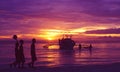 Philippines: Thre local football-boys walking along the beach