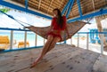 Philippines, woman red underwear in hammock