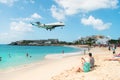 Philipsburg, Sint Maarten - February 13, 2016: jet flight land over maho beach. Plane low fly on cloudy blue sky Royalty Free Stock Photo