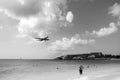 Philipsburg, Sint Maarten - February 13, 2016: plane land over maho beach. Jet flight low fly in cloudy sky. Airplane on Royalty Free Stock Photo