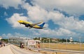 Philipsburg, Sint Maarten - February 13, 2016: plane low fly over maho beach. Jet flight land on cloudy blue sky Royalty Free Stock Photo