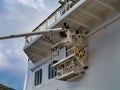 Philipsburg, St Maarten - 24 Jan 2024: A worker on a boom lift or cherry picker works next to a maintenance platform