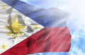 Phillipines waving flag against blue sky with sunrays