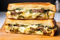 philly cheesesteak sandwich sliced in half, showcasing the filling