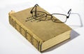 Philosophical dictionary and glasses lying on a white surface Royalty Free Stock Photo