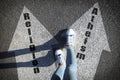 Philosophical or religious position. Woman standing on road marking arrow with word Atheism, closeup Royalty Free Stock Photo