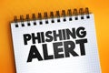 Phishing Alert text quote on notepad, concept background Royalty Free Stock Photo