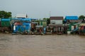 A small shanty town, squatter settlement of poor houses of wood and corrugated metal, Mekong River