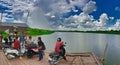 Cars, motorbikes and people on a ferry crossing the Mekong river Royalty Free Stock Photo