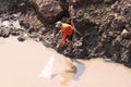 A fisherman pulling a net from the river for fishing in Phnom Penh