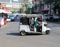 Tuk Tuk or Taxi tricycle on the road, Lifestyle of traffic in Phnom Penh. It is a three-wheeled motorized vehicle used as a taxi